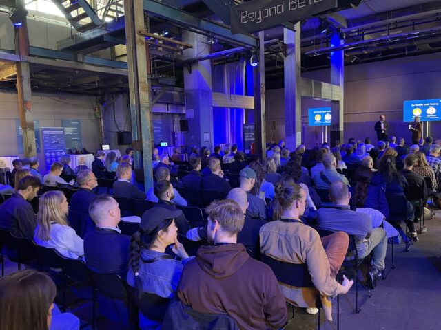 Participants at Beyond Beta Summit 2025, listening to a speak